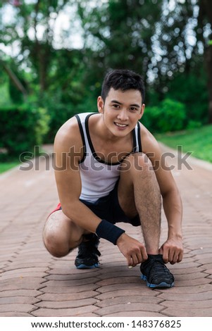 Full-length portrait of a happy jogger posing at camera