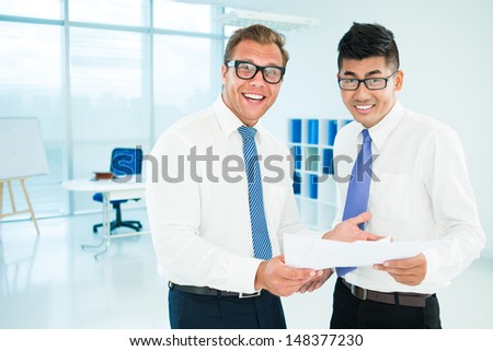Portrait of joyful businessmen debating at the office