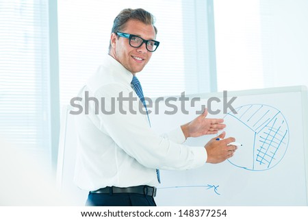 Portrait of a handsome businessman explaining business strategy on the seminar