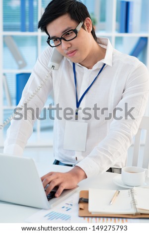 Vertical image of a busy businessman in the heat of the working day