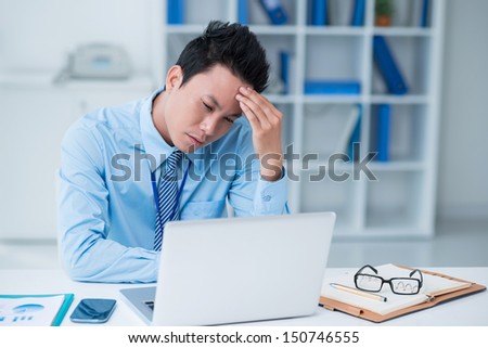 Copy-spaced image of a tired businessman sitting at the office