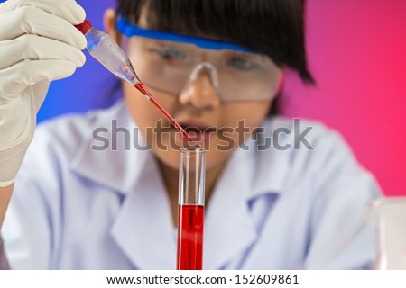 Image of a young chemist with a test-tube and a dropper on the foreground