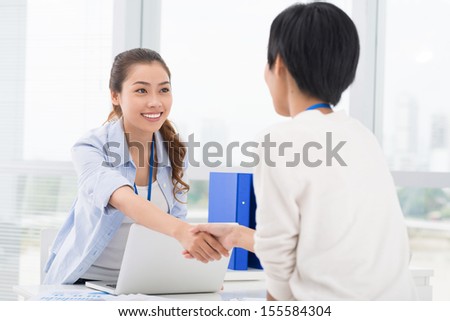 Image of businesswomen handshaking in the sign of agreement