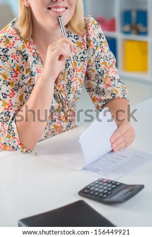 Cropped image of a female secretary working with documents on the foreground