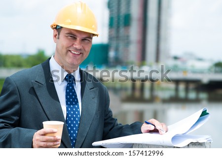 Copy-spaced portrait of an engineer having coffee break outside