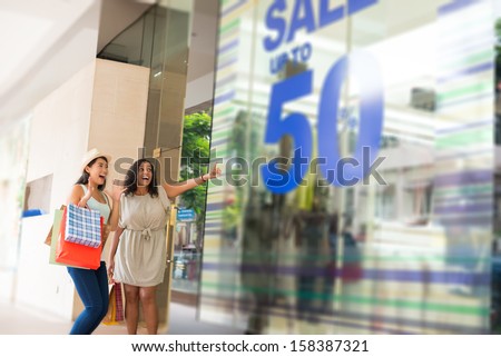 Image of excited shopaholics being excited of the sale in the mall standing on the foreground