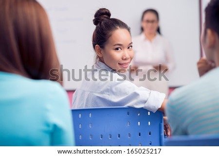 Portrait of a student during the lesson posing at camera on the foreground