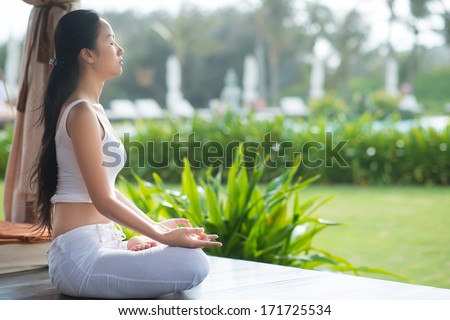 Side view of a meditating woman