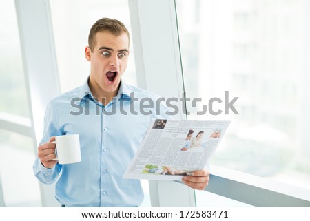 Man getting excited while reading paper