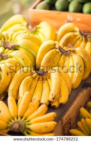 Vertical image of bunches of ripe bananas on the fruit stall
