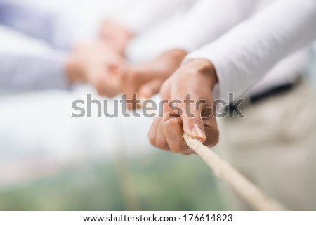 Concept Image Of Business Team Using A Rope As An Element Of The Teamwork On The Foreground