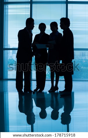 Vertical blurry image of a business team discussing the strategy