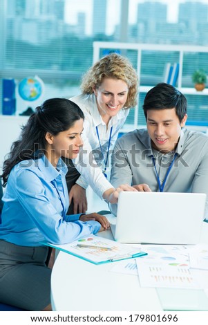 Vertical image of business colleagues cooperating to achieve better results for their company