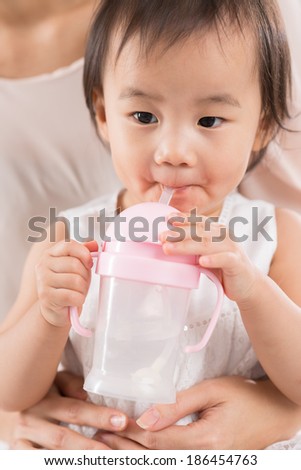 Chinese toddler drinking from feeding bottle