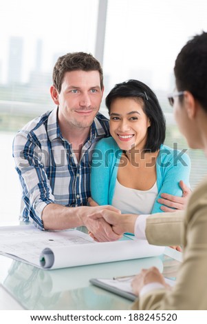Young family and broker making a deal