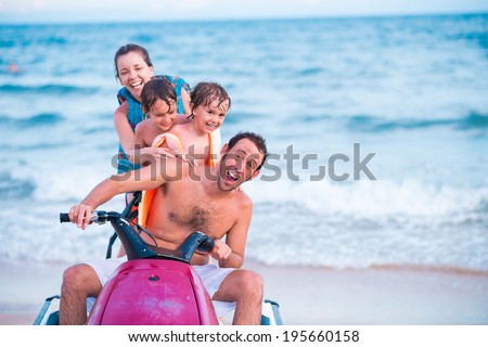 Excited family riding jet ski