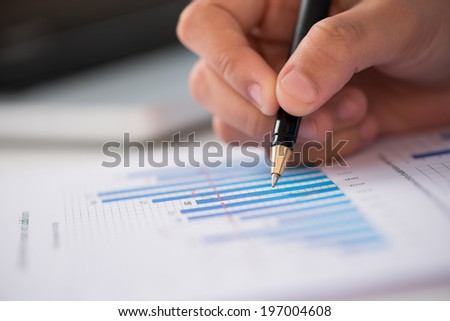 Close-up of businessperson working with statistics