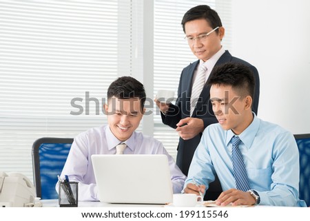 Asian managers working on presentation