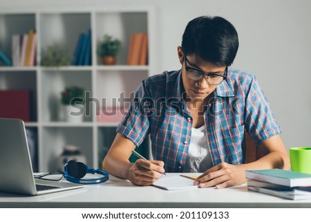 College student doing homework at home