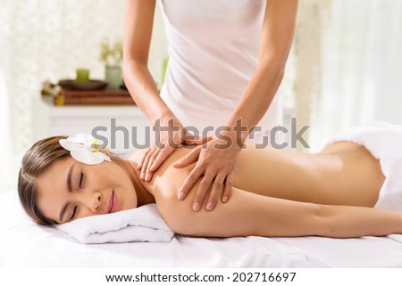 Woman getting professional back massage in spa salon