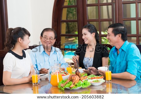 Asian family talking during the dinner