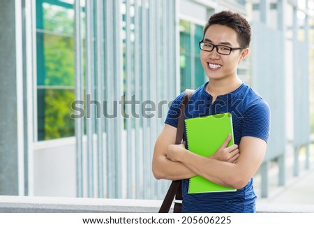 Portrait of happy Vietnamese student with a textbook