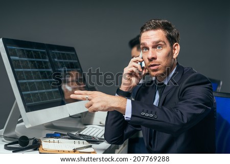 Stock market trader showing a gesture of the number seven