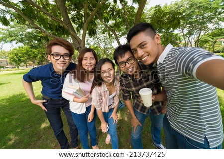 Group of Asian students taking selfie in the park