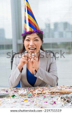 Portrait of middle-aged business woman in a party hat