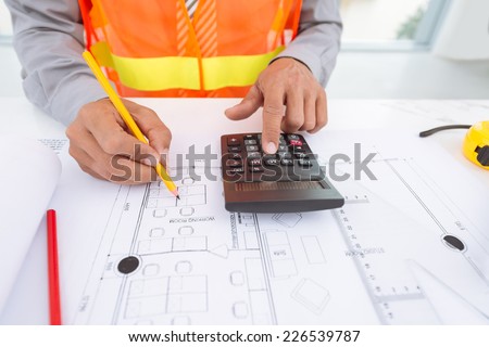 Cropped image of architect doing calculations