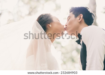 Just married couple kissing for the first time