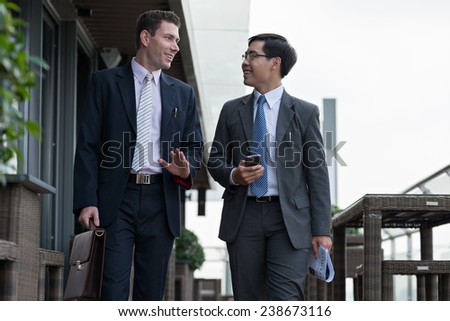 Business colleagues talking while going to work