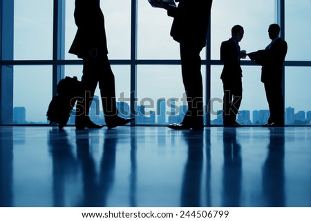 Group of business people standing against the window in the office
