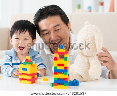 Vietnamese man playing with his cute little child
