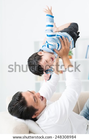 Happy father lifting his child