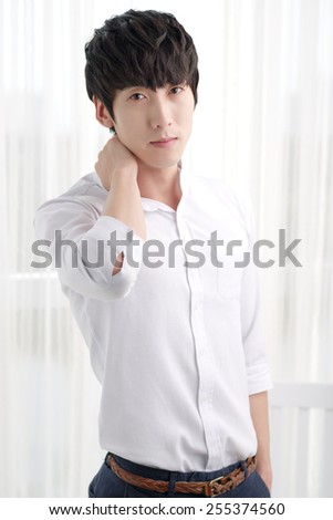 Good-looking young man in a white shirt