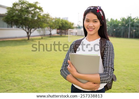 Portrait of happy Vietnamese college student on campus