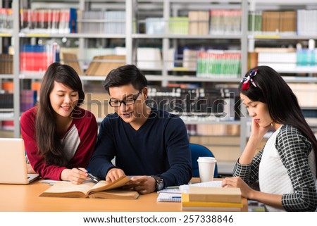 Group of Vietnamese college student doing homework in a library