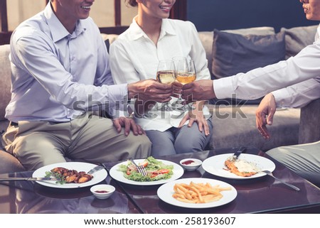Cropped image of business colleagues toasting at the dinner