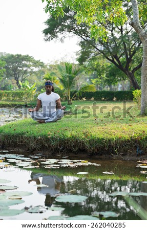 Man meditating outdoors alone