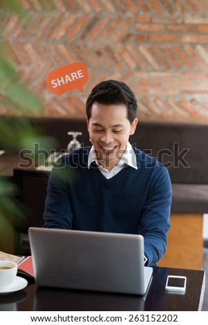 Smiling man sharing information on social network