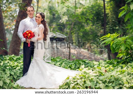 Happy multi-ethnic wedding couple in the park