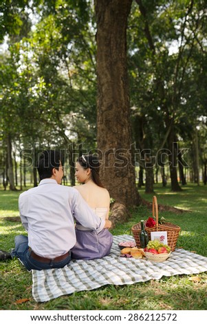 Young people dating on picnic in park