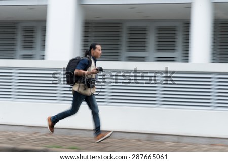 Professional photographer running in the street