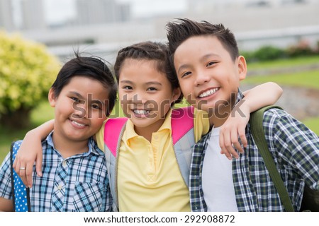 Portrait of happy hugging primary school children