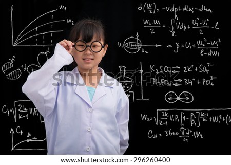 Vietnamese girl in glasses and labcoat standing at the blackboard with formulas