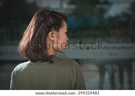 Rear view of young woman with cute braided hairstyle on short hair