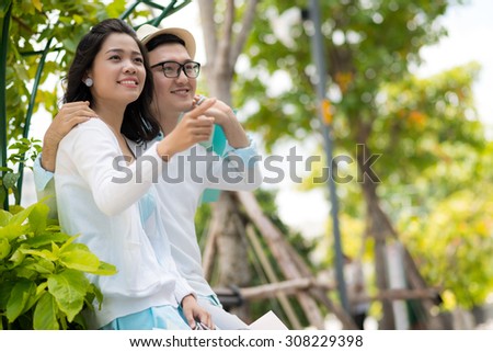 Young Vietnamese couple having date in the park