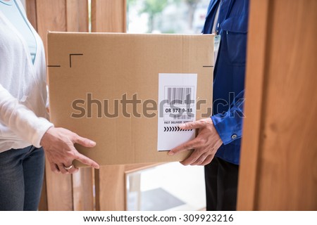 Cropped image of fast delivery service worker giving parcel to the client
