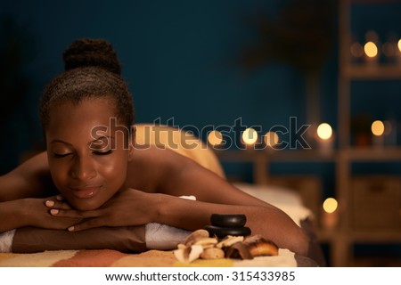 Lovely African-American woman spending her day in spa salon
